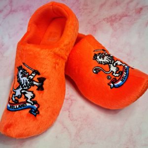 Orange slippers with embroidered lion and 'Holland' text.