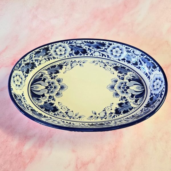 Blue floral patterned ceramic bowl on pastel background.