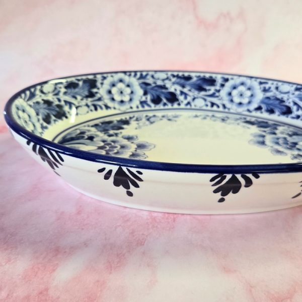 Blue floral ceramic plate on pink background