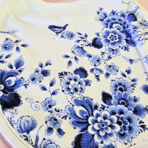 White shirt with blue floral pattern design.