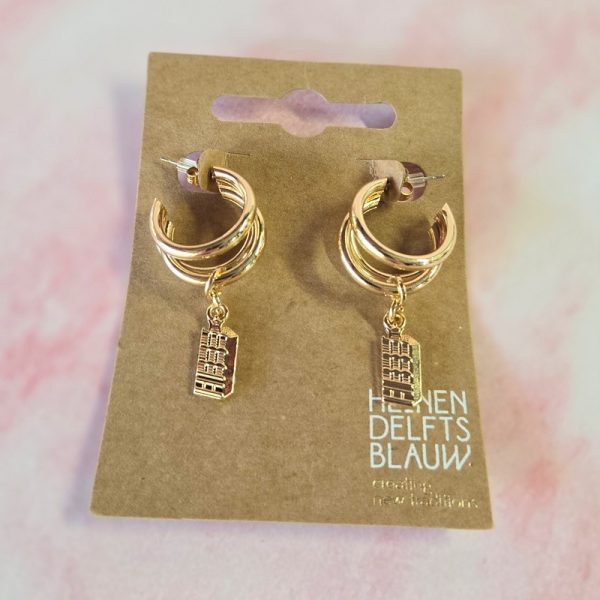 Gold hoop earrings with building charm design.