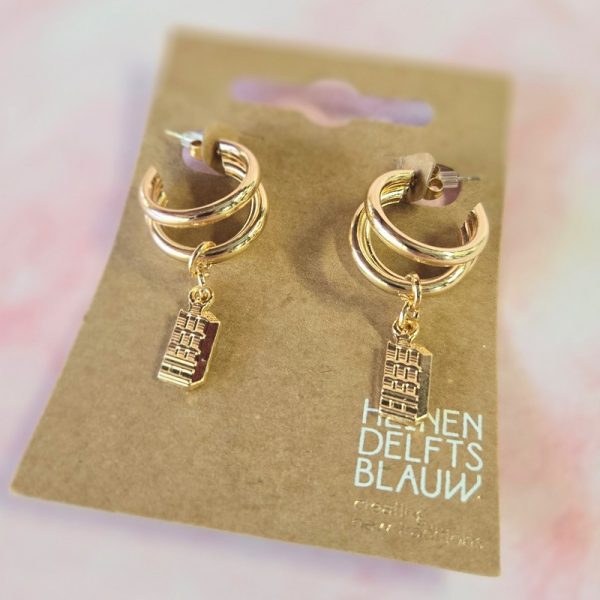 Gold earrings with pendant on display card.
